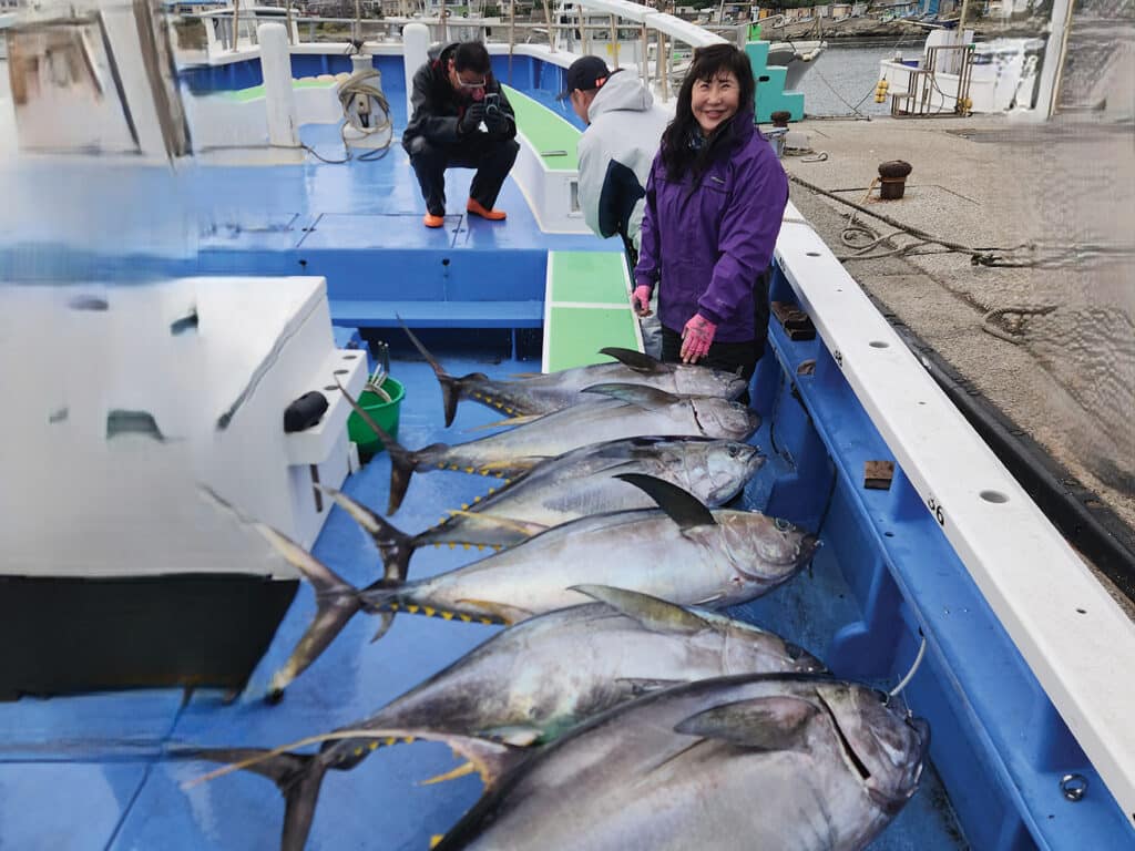 Lisa Kitagawa next to a catch of tuna.
