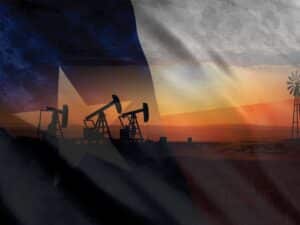 Texas flag overlaid a Texan landscape featuring oil wells