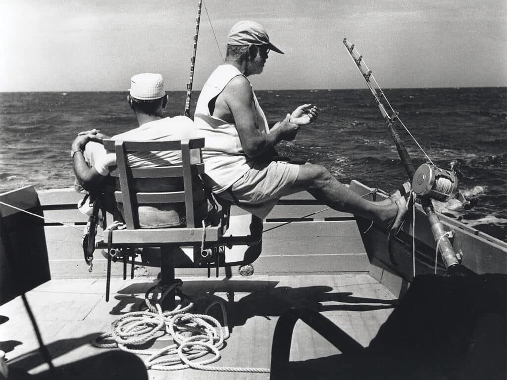 Black and white image of Ernest Hemingway sport-fishing
