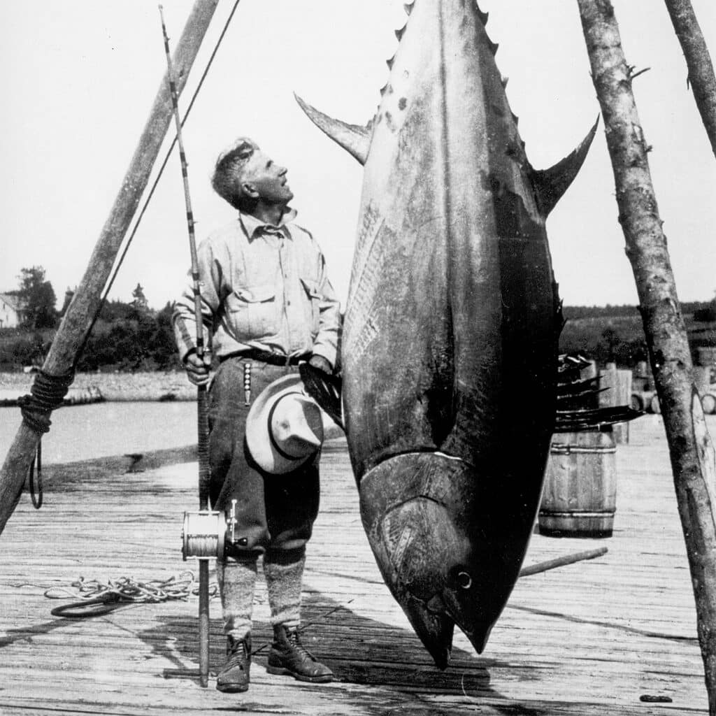 Zane Grey next to a large tuna.