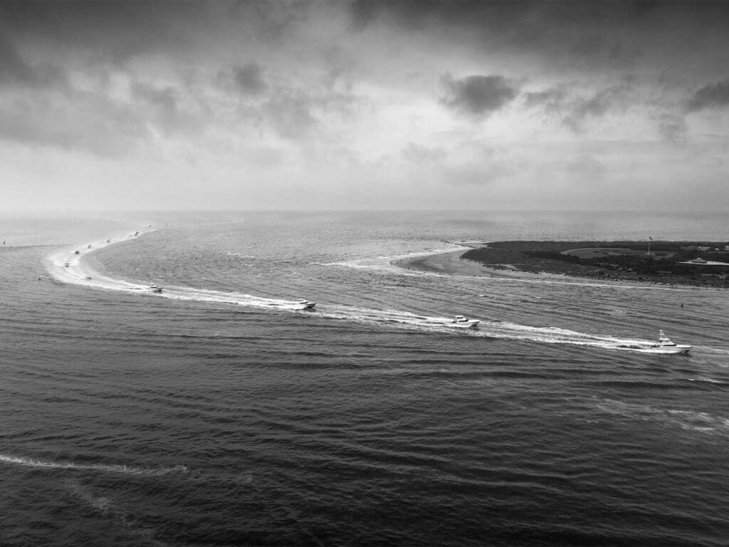 Black and white image of a fleet of sport-fishing boats.