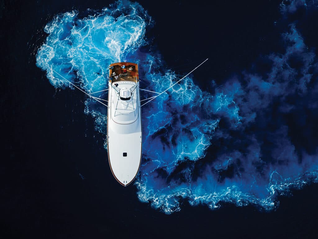 Sport-fishing boat running on water.